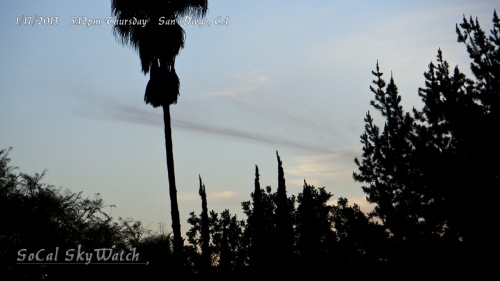 5:12pm Chemtrail line clouds falling into shadow at sunset.
